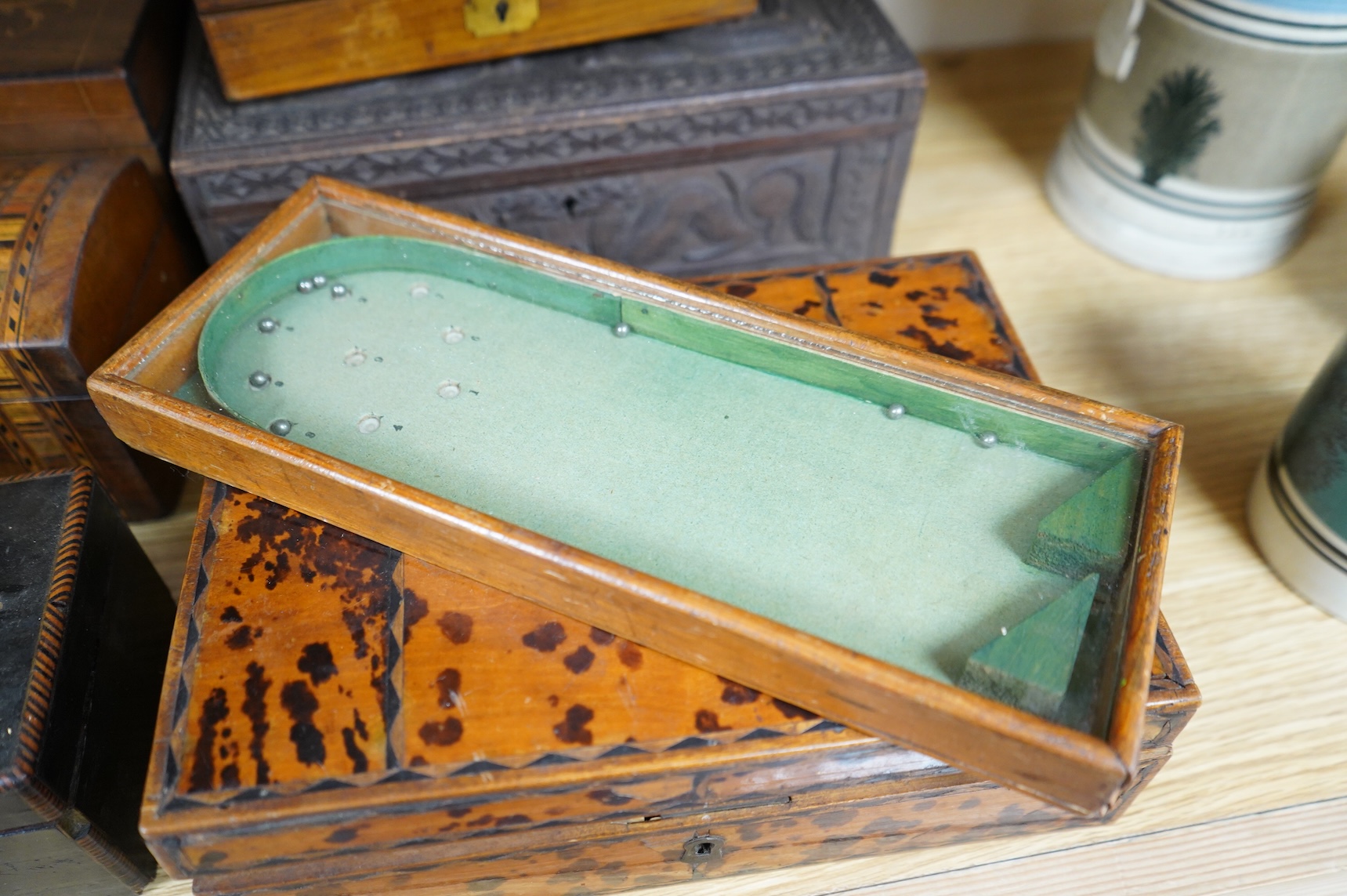 A blonde tortoiseshell veneered box, six other boxes and a miniature bagatelle board